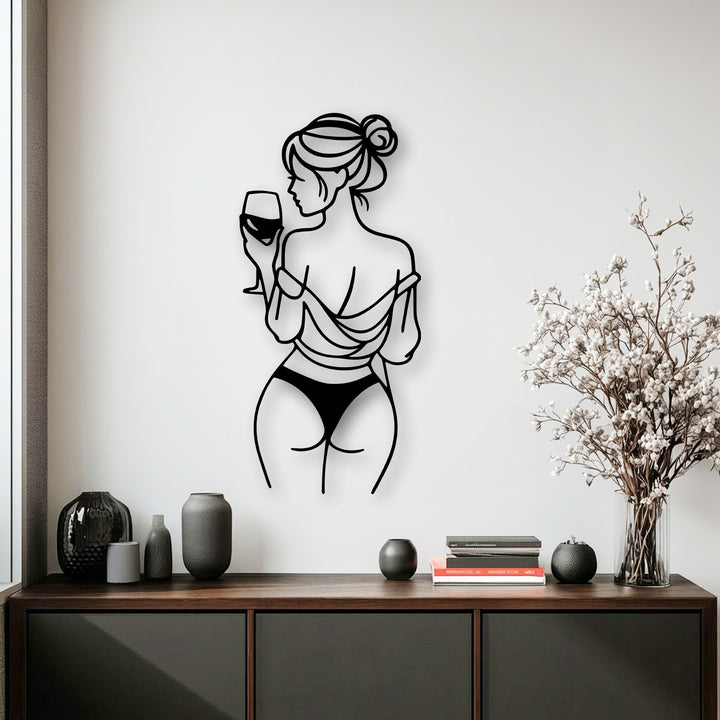 Subtle shadows softly trace the contours of the elegant wine moment unique metal wall art, enhancing its minimalist line art profile on the bright white wall.