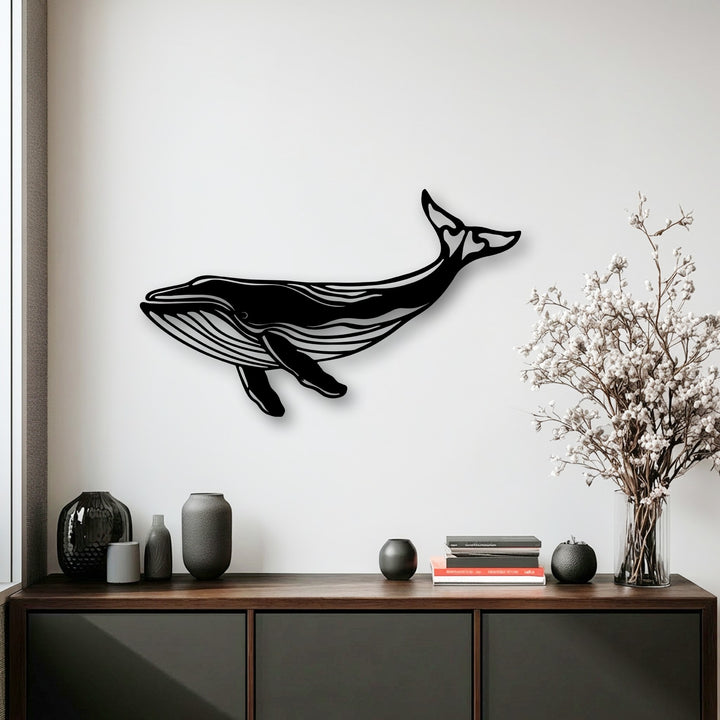 The visual rhythm of the sleek black whale silhouette metal artwork creates a harmonious flow across the bright white wall, complemented by elegant decor.