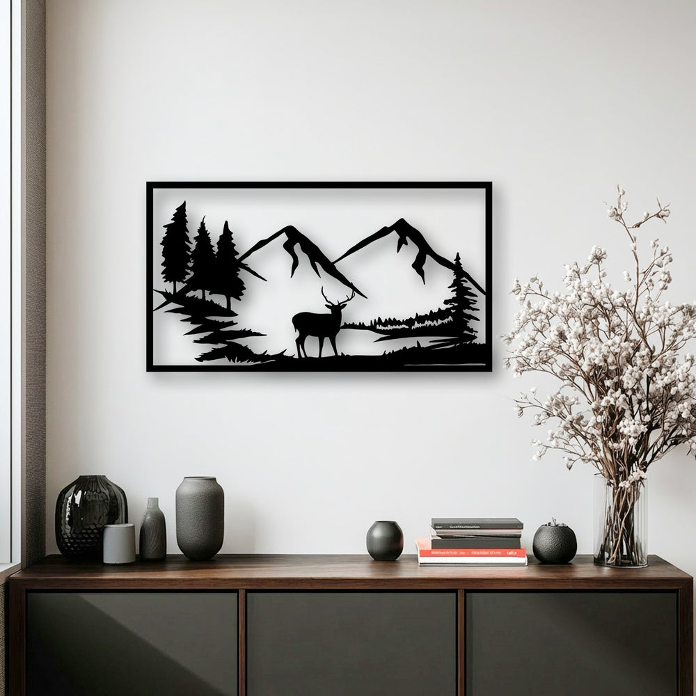 The bright white wall highlights the striking black silhouette of unique metal wall art featuring a majestic mountain deer and nature landscape.
