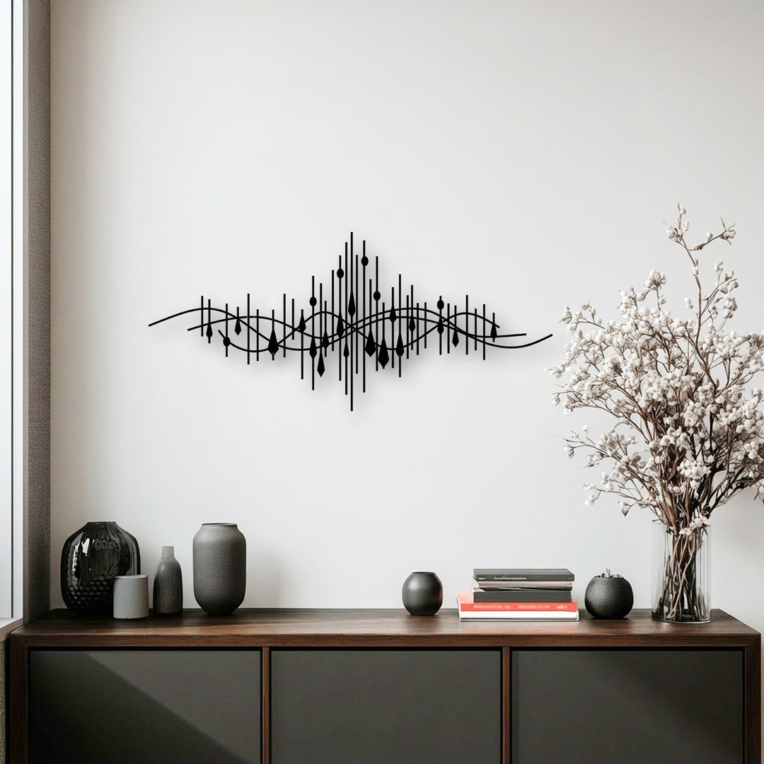 Organic forms subtly shape the abstract soundwave decorative metal art, featuring undulating lines and teardrop elements.