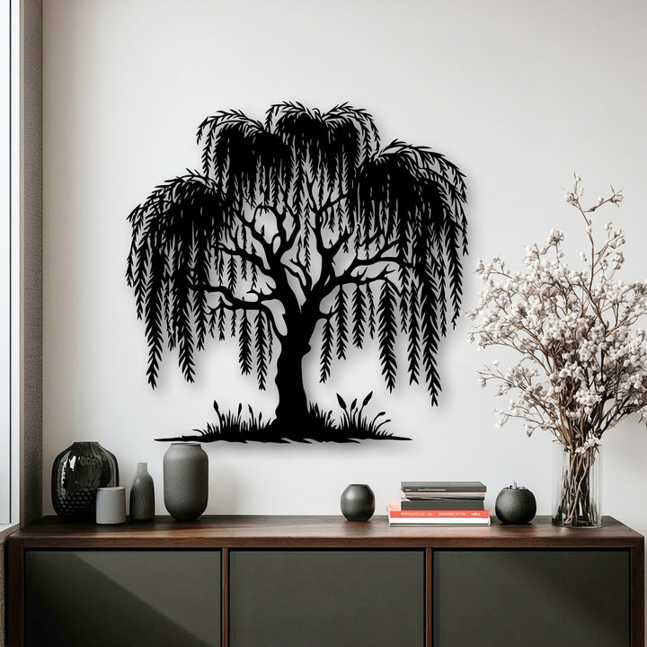 A pristine white wall serves as the background for elegant metal artwork featuring a graceful willow tree silhouette.
