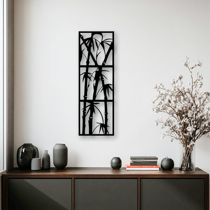 The interplay of light and shadow beautifully defines the intricate black bamboo metal artwork, adding dramatic depth to the minimalist scene.