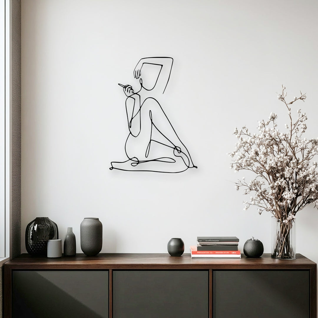 The dark minimalist female line art metal wall decor exhibits a crisp color contrast against the bright white wall, serving as striking decoration wall art.