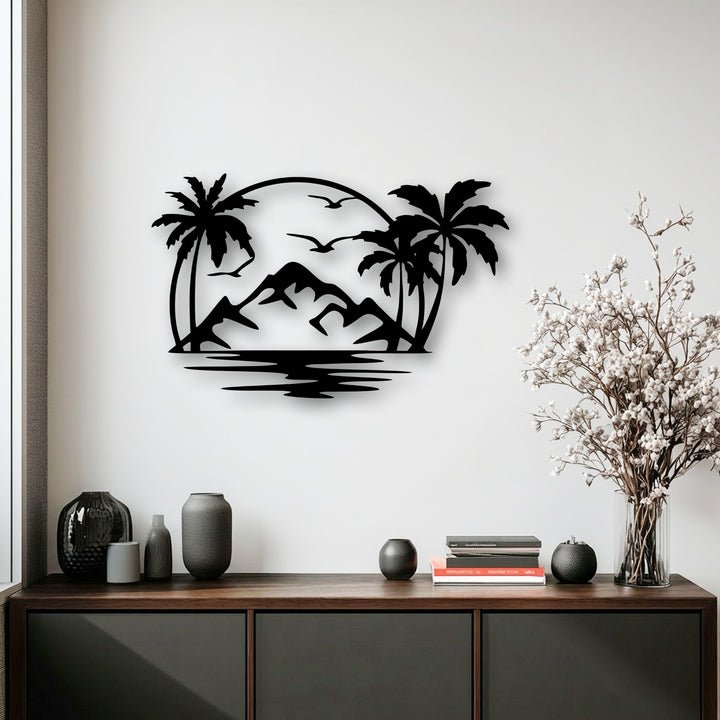 A matte black finish defines this metal artwork, showcasing a striking tropical island scene with palm trees, mountains, and an ocean.