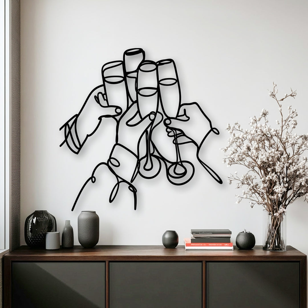 The graceful transition of color from the bold black Celebration Line Art metal art for wall against the crisp white wall to the dark furniture is striking.