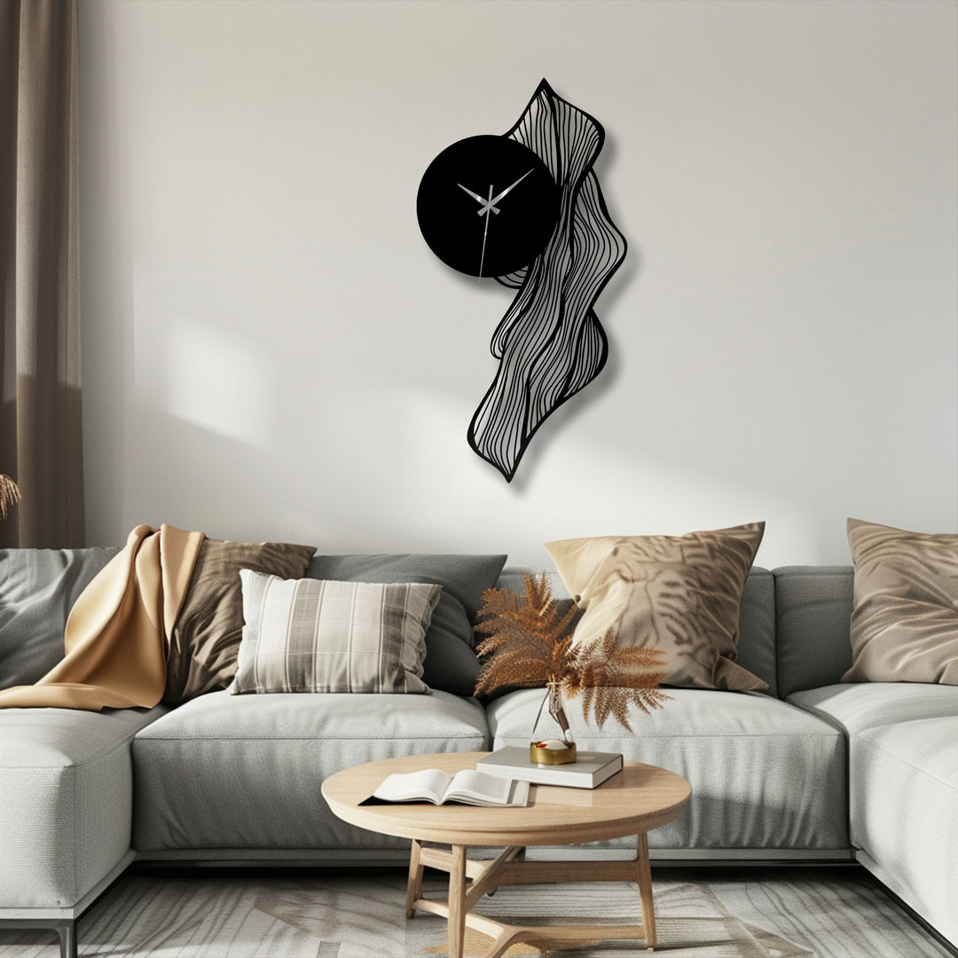 Matte black finish highlights the flowing abstract lines and adds to the unique metal wall art clock's modern artistic decor.