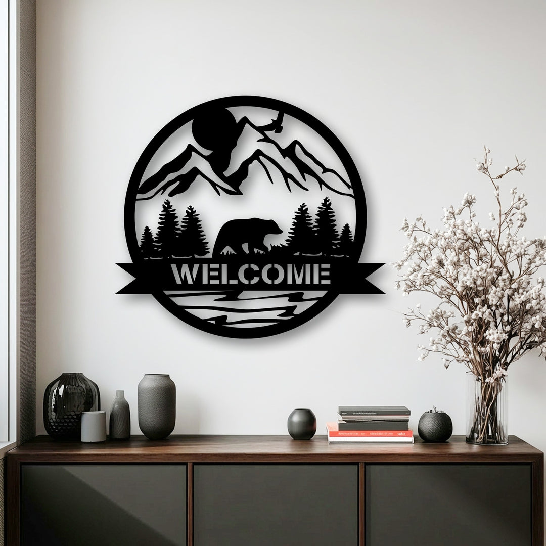 The foreground features a dark wood credenza holding decorative vases, stacked books, and a textured sphere, complementing the metal decoration wall art.