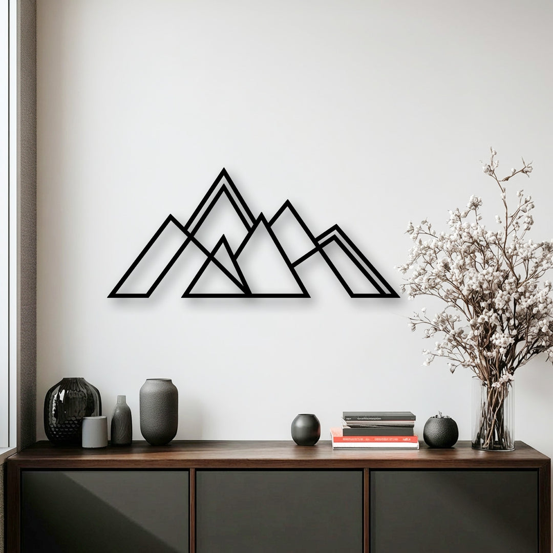 Organic forms, such as the delicate white flowers and textured vases, provide a soft contrast to the geometric mountain metal decoration wall art.