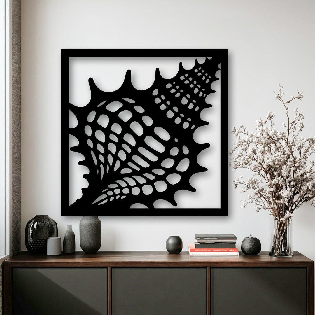 Impressive depth and intricate layers define this black seashell metal wall decor, casting dramatic shadows against the bright white wall.