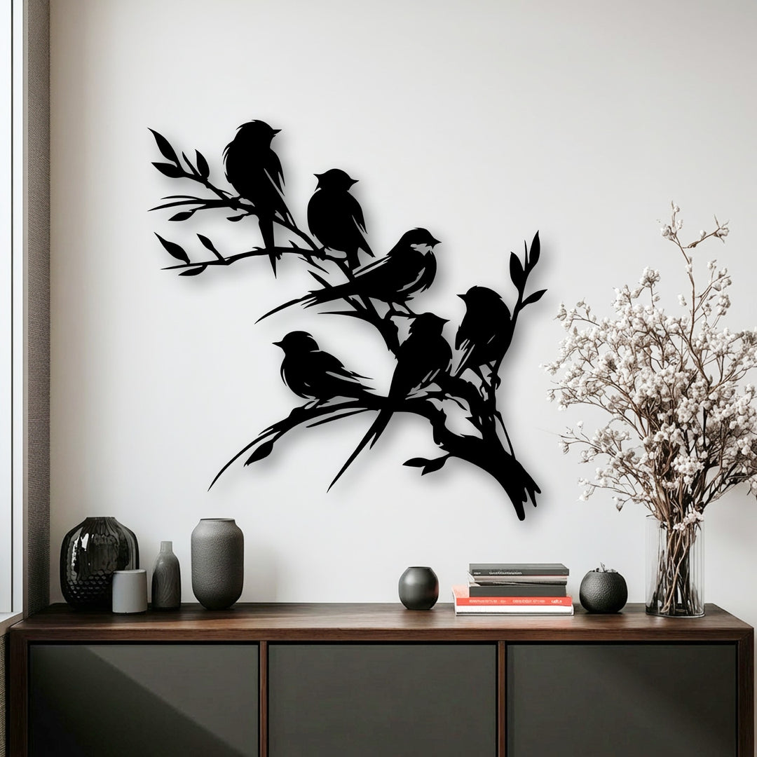 White walls showcase unique metal wall art featuring black silhouetted birds on a branch, an elegant nature silhouette decor piece.