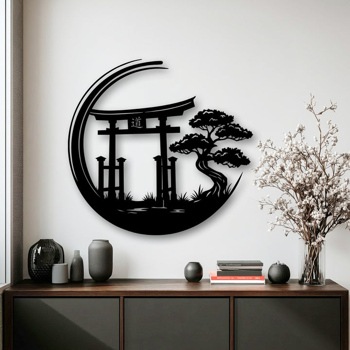 A neutral color temperature highlights the striking black Zen Garden Torii Gate metal art for wall, contrasted by warm wood and delicate white flowers.