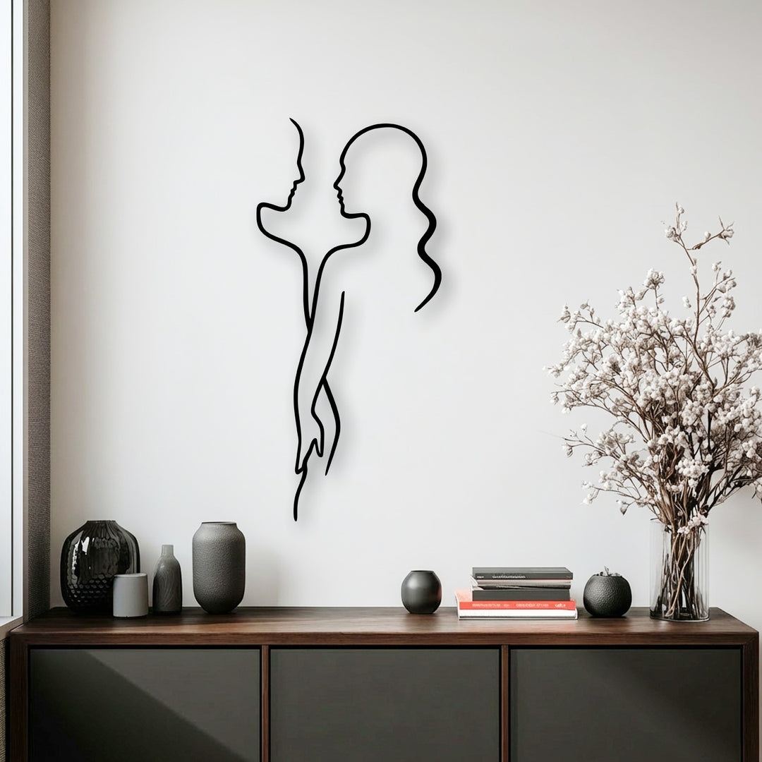 Showcasing fascinating depth and layers, this Minimal Couple Line metal wall decor features abstract profiles on a pristine white wall.