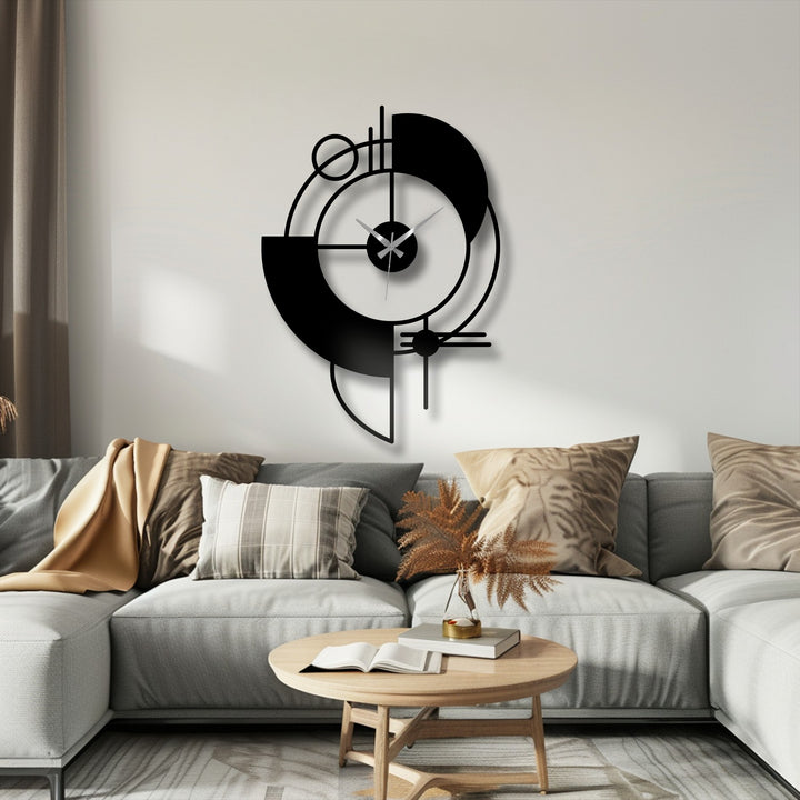Foreground view of the round wood coffee table with an open book, complementing the abstract geometric metal artwork clock hanging behind it.