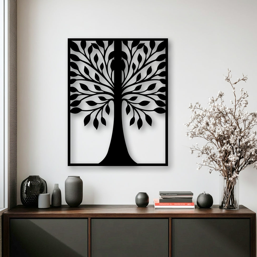 A bold, black symmetrical leaf tree silhouette, as decorative metal art, stands out against a minimalist white wall.