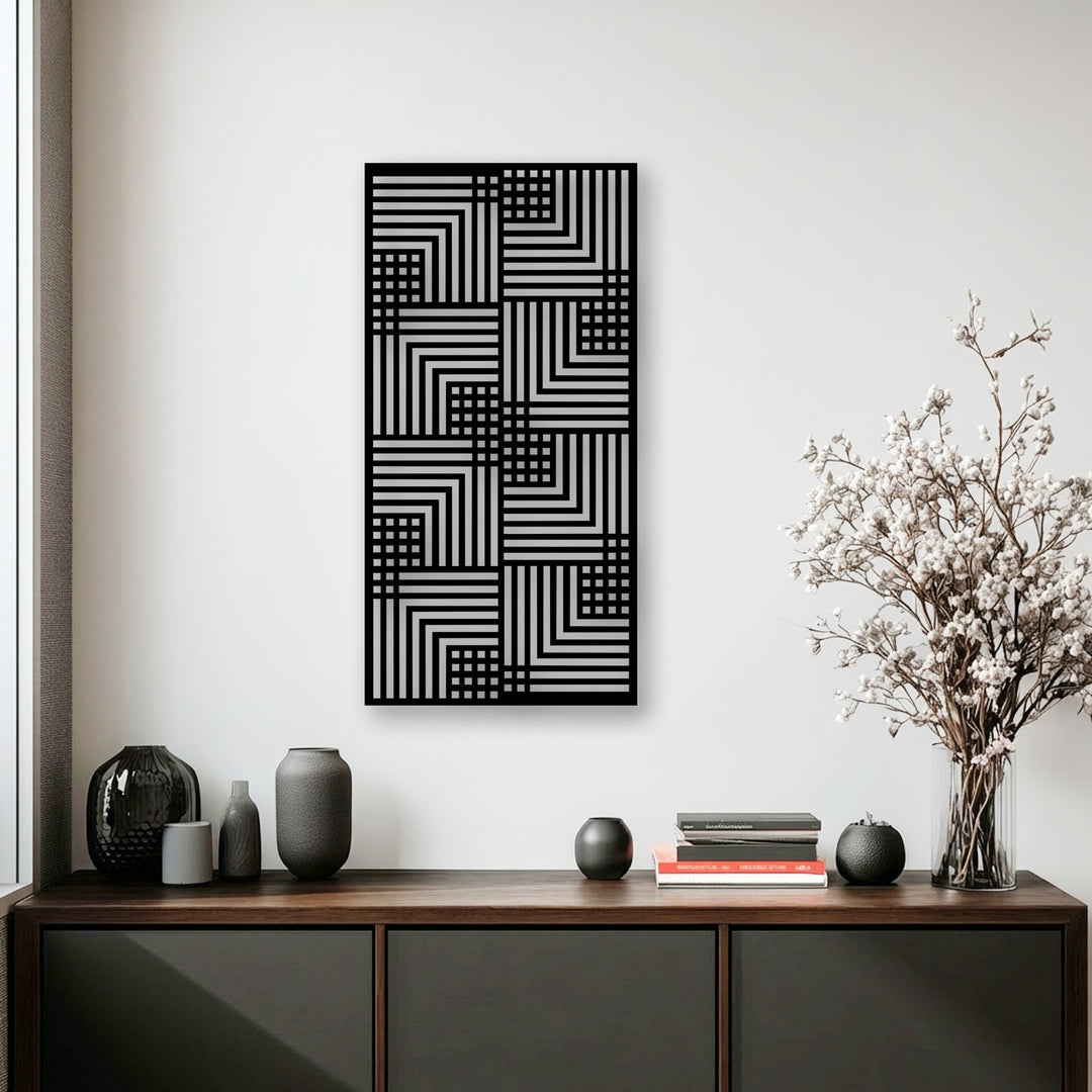Geometric elements of a unique metal wall art feature a modern linear pattern in black and silver, creating a striking visual rhythm.