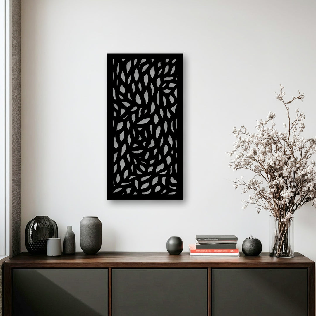 Organic forms create a stunning visual, featuring an abstract leaf pattern metal artwork panel casting soft shadows on a bright wall.