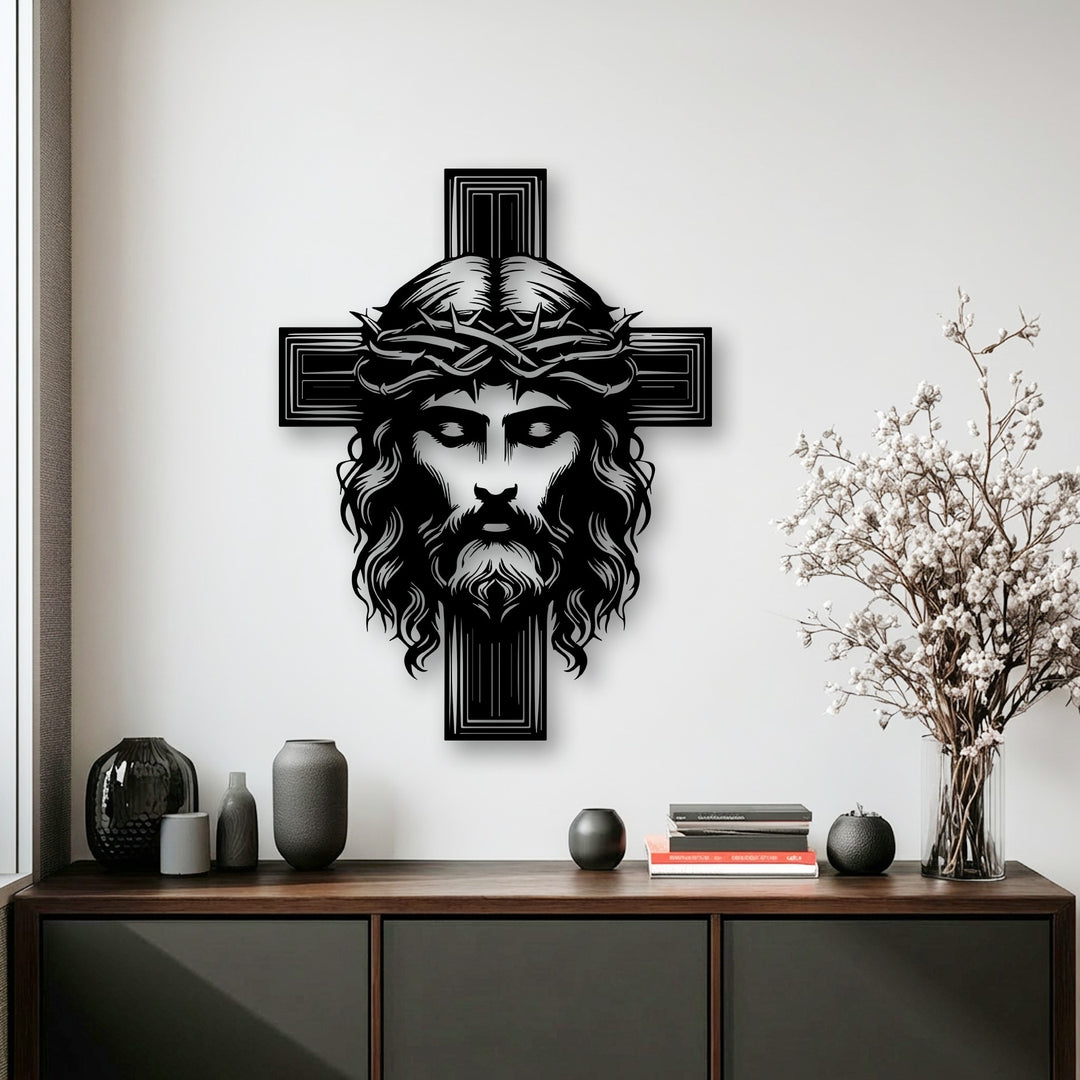 The prominent and intricately designed black unique metal wall art featuring Christ's face with a crown of thorns on a cross.