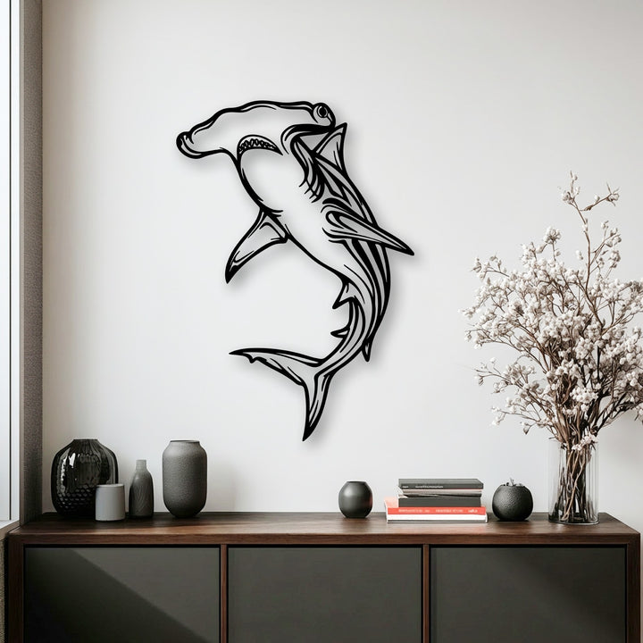 The cool, bright color temperature of the room accentuates the striking hammerhead shark metal artwork against a stark white wall.