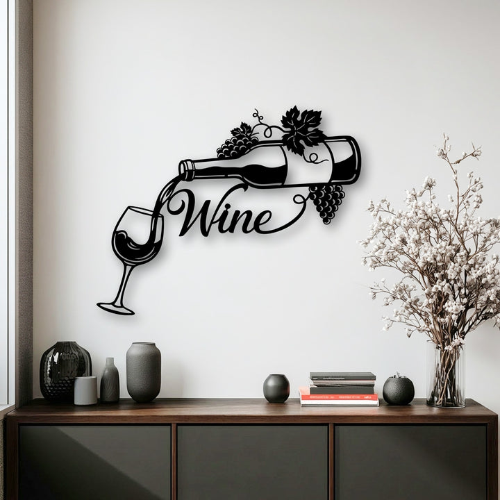 A pristine white wall showcases unique metal wall art featuring an elegant pouring wine bottle and glass with grape accents.