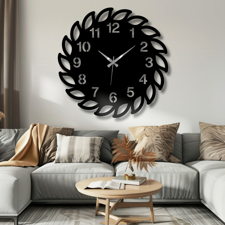 Warm color temperature highlights the unique metal wall art of a decorative leaf frame wall clock in a modern nature-inspired design.