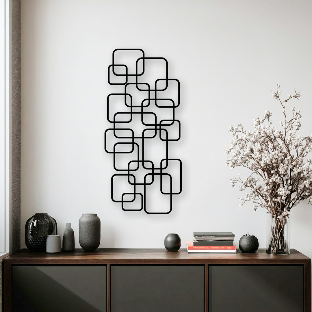 Light and shadow play across the interlocking squares of this modern geometric metal art for wall, creating dynamic contrast.