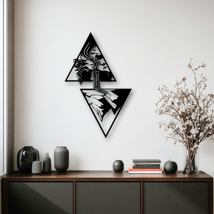 The bright white wall highlights the striking black geometric waterfall metal art for wall, showcasing a serene nature landscape.