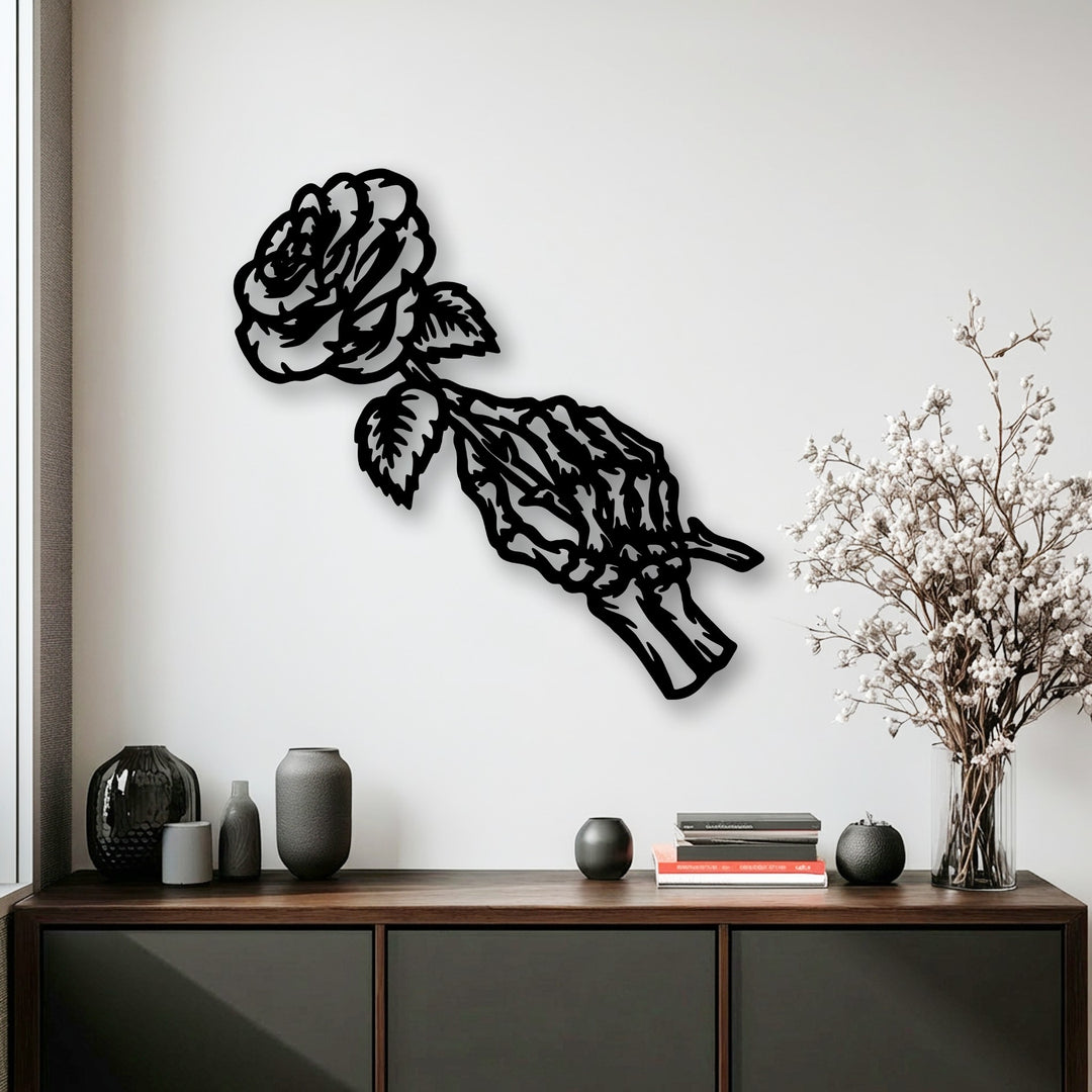 The sharp, clean-cut borders of this unique metal wall art depict a gothic floral rose skeleton, casting a striking shadow on the white wall.