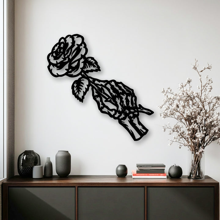 The sharp, clean-cut borders of this unique metal wall art depict a gothic floral rose skeleton, casting a striking shadow on the white wall.