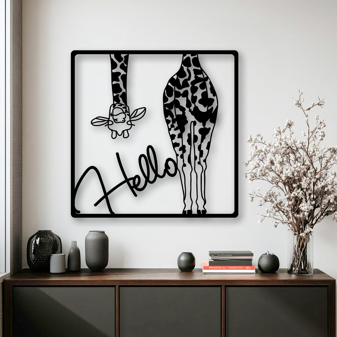 A striking black metal wall decor piece, showcasing playful giraffes and the word 'Hello' in bold script, serves as the loudest element.