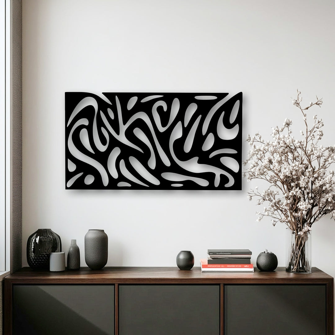 Abstract fluid pattern metal artwork featuring dynamic swirling white shapes on a sleek black panel, creating a striking modern design.