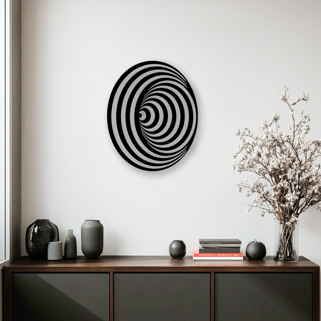 The dominant light grey and white hues highlight the striking black and white hypnotic spiral circle metal art for wall.