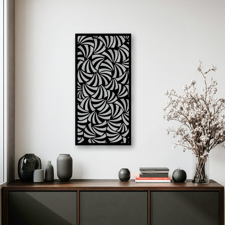 A striking metal art for wall, showcasing a swirling geometric pattern that forms captivating depth and layers on a contrasting black backdrop.