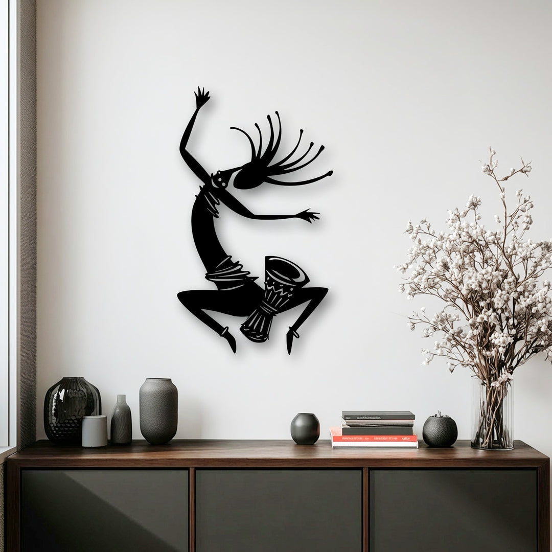 Subdued color saturation emphasizes an energetic tribal dance silhouette metal art for wall, complementing understated decor.