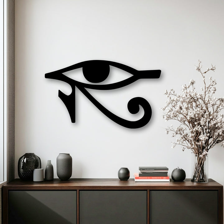 Observe the realistic detail of the black Eye of Horus unique metal wall art, showing its textured finish and subtle shadow on the bright white wall.