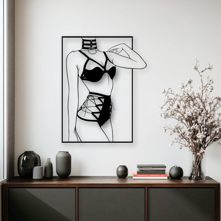 Bold black metal art for wall depicting a minimalist female silhouette in modern line art style, displayed on a pristine white wall.
