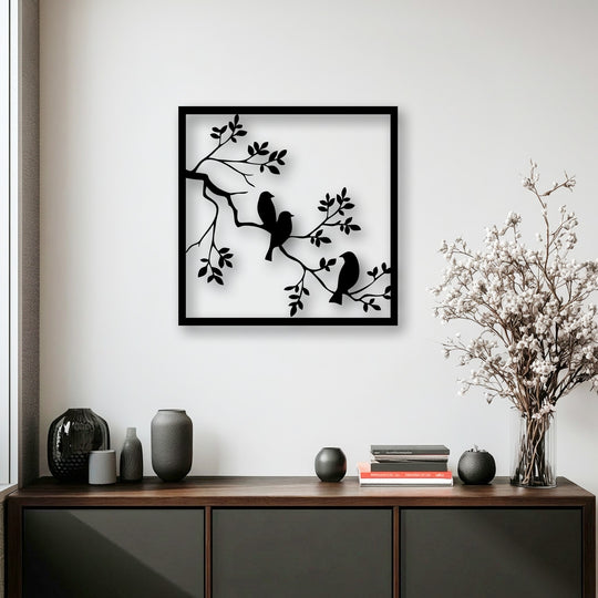 A pristine white wall serves as the perfect backdrop for the striking birds on branch unique metal wall art.