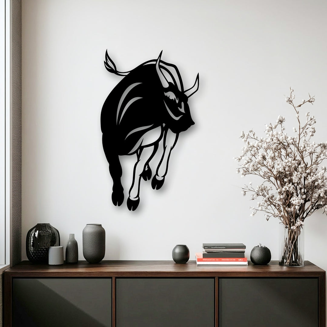 The dynamic composition of the charging bull metal wall decor creates a powerful visual rhythm, capturing intense motion.
