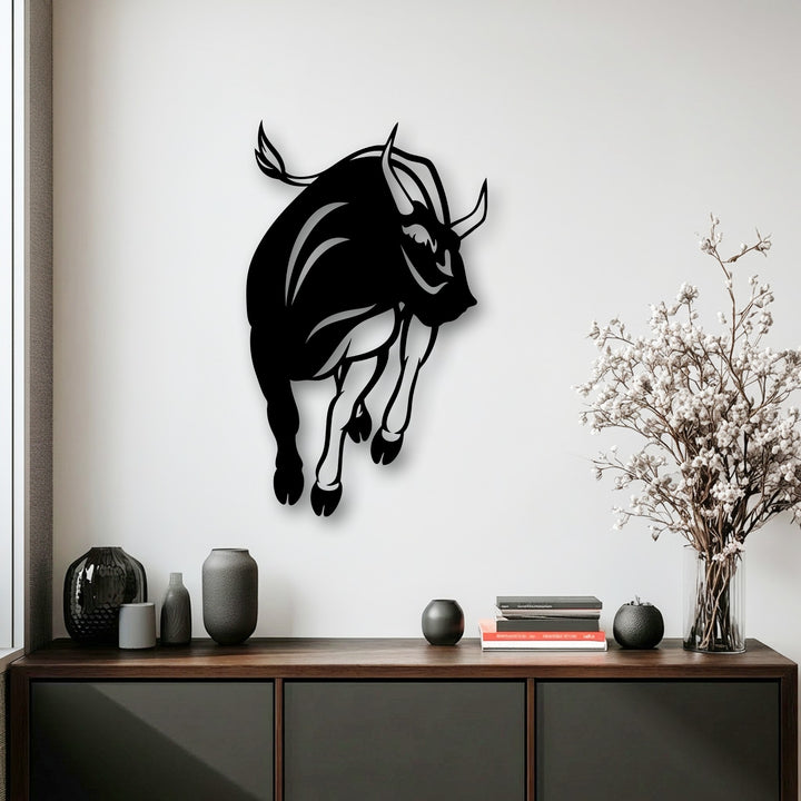 The dynamic composition of the charging bull metal wall decor creates a powerful visual rhythm, capturing intense motion.
