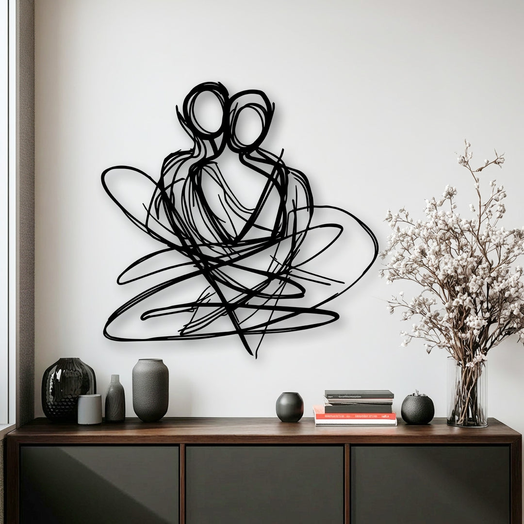 Soft light walls highlight a bold black abstract couple metal wall art, forming a sophisticated display of decorative metal art.
