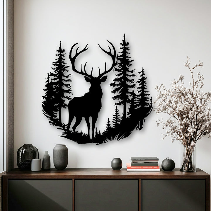 Delicate white blossoms in a clear vase complement the captivating unique metal wall art featuring a majestic deer in a forest.