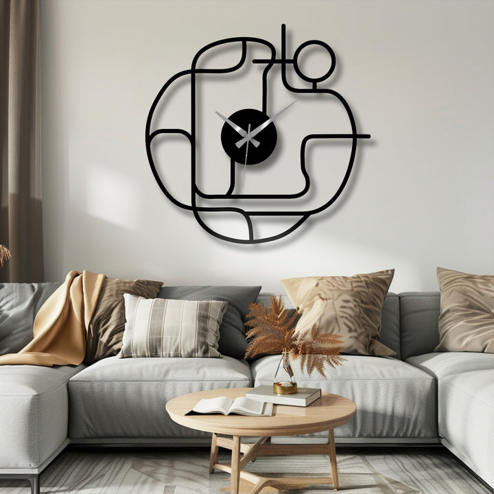 Warm-toned light enhances the matte black finish of this abstract line unique metal wall art clock, casting a soft shadow on the wall behind the modern couch.