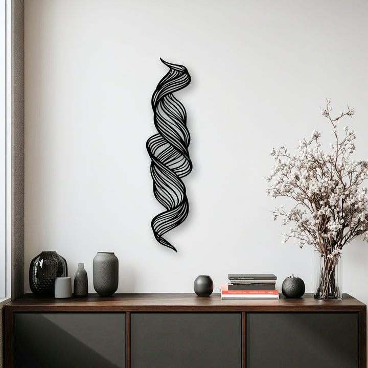 The negative space intricately carved by the twisted flow abstract metal art for wall creates a dynamic, winding visual effect.