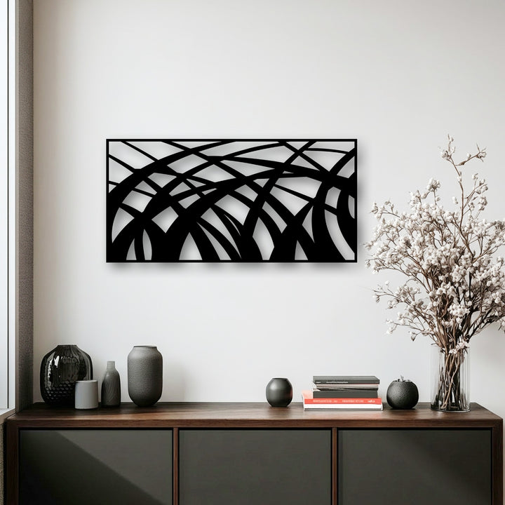 The darkest area features the bold black abstract metal wall art, a unique flowing geometric wave decoration wall art.