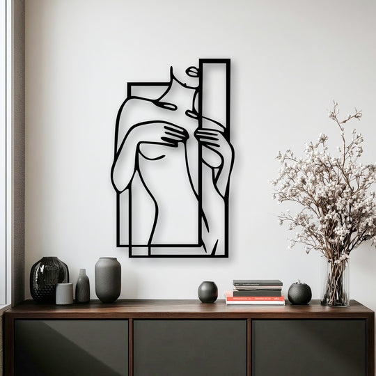 The focal point is an elegant minimalist female figure line art, a unique metal wall art piece with a striking black outline and geometric frame.
