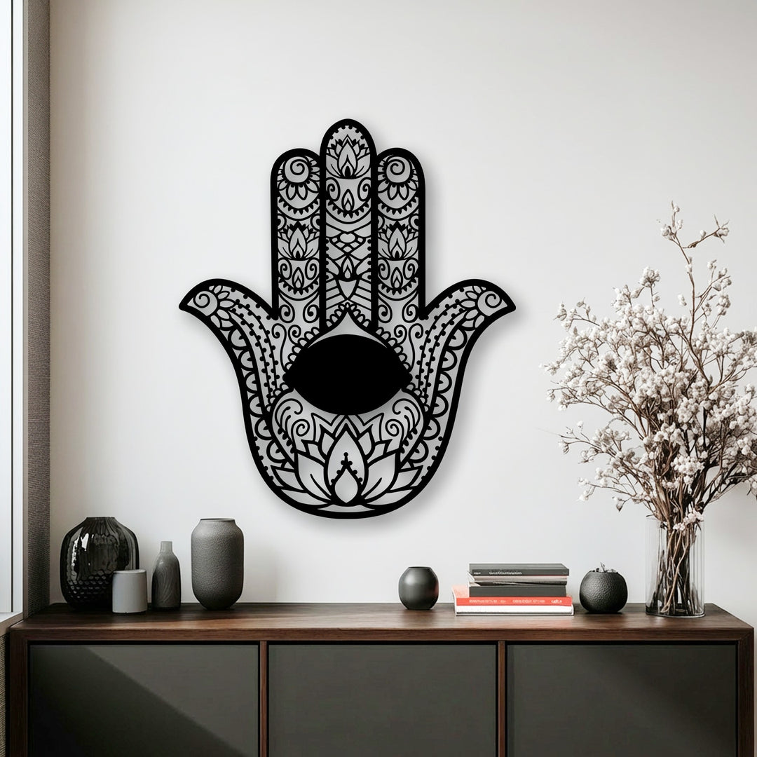 Intricate geometric patterns form the Hamsa hand, featuring an oval evil eye and decorative cut-outs as striking metal wall decor.