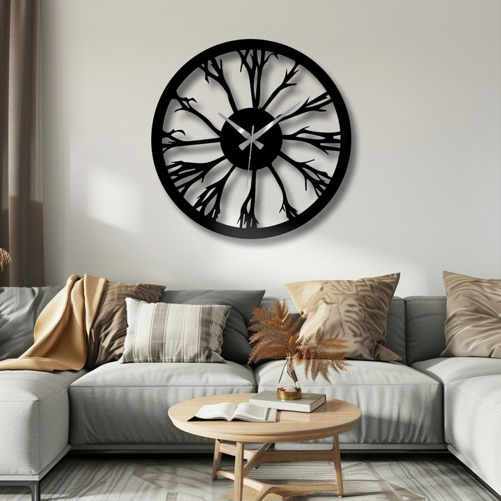 The tree silhouette's organic forms create a striking, nature-inspired unique metal wall art clock, radiating from the center with twig-like metal branches.