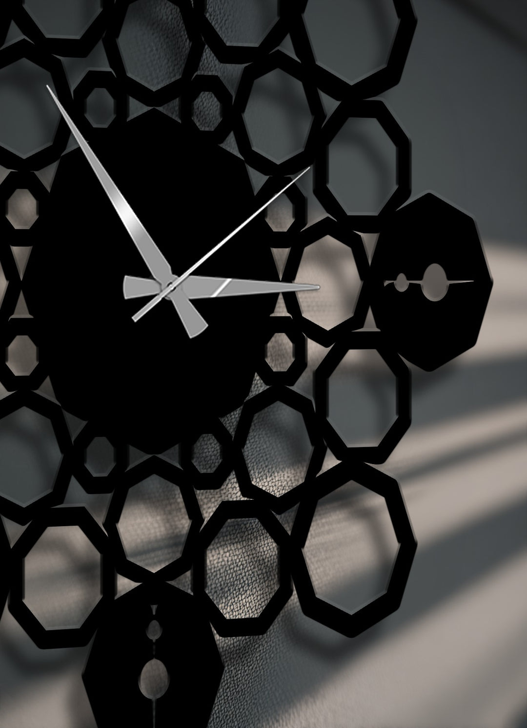 The organic forms of the black geometric mandala metal wall decor clock feature interconnected octagons casting soft shadows, creating a subtle flow.