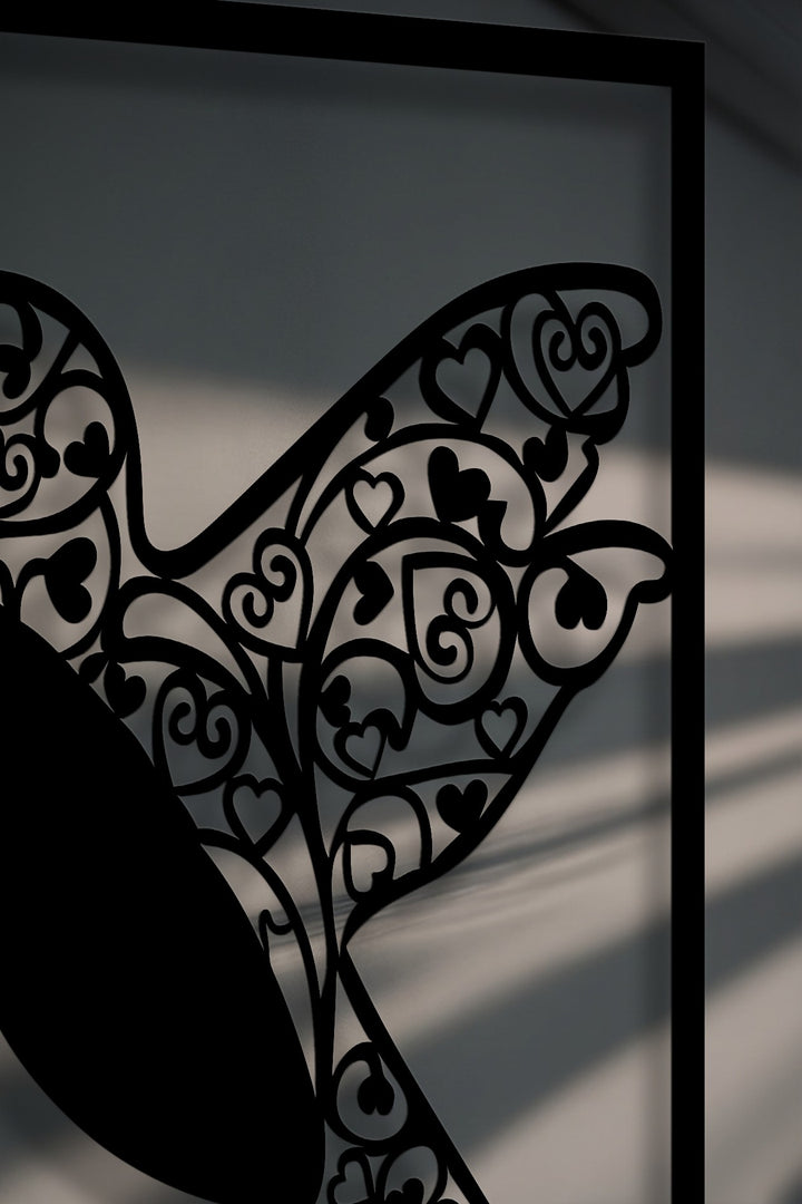 The brightest area shows the delicate shadows cast by the intricate hummingbird heart metal art for wall.