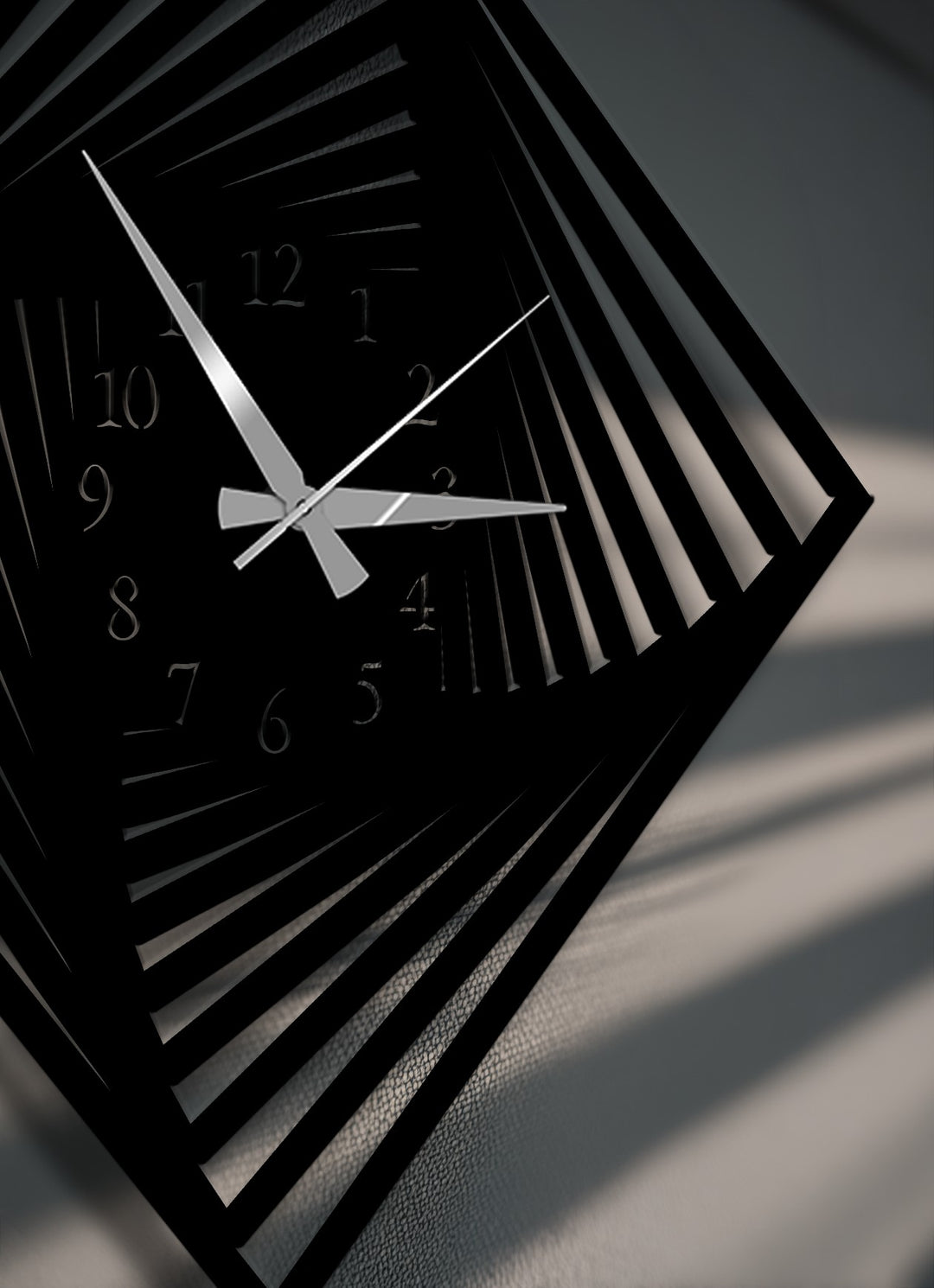 The stillness of the stationary silver hands on this modern twisted square metal artwork wall clock emphasizes its captivating optical design.