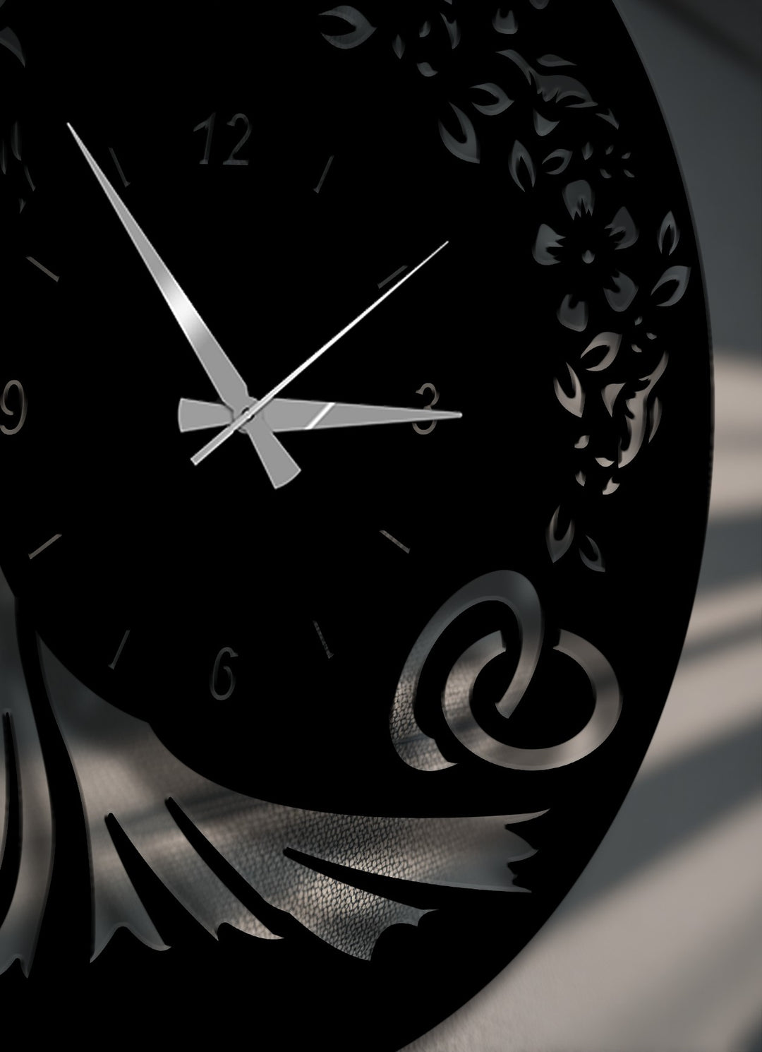 Striking color contrast on this decorative metal art piece, featuring a sleek black metal wall clock with shimmering silver hands and intricate cut-out designs.